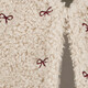 Fluffy meisjes gilet met strikjes beige